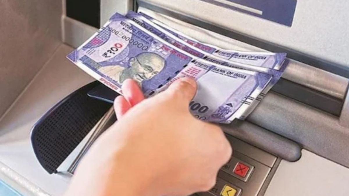 A person is using the BCA mobile app on their phone to withdraw money from an ATM.